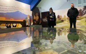 Visitors exploring the Legends of Kildare exhibit, featuring Irish myth-inspired murals and a reflective model landscape.