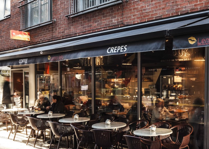Outdoor seating at Lemon Jelly Café in Dublin with customers enjoying crepes, coffee and a relaxed street-side atmosphere.