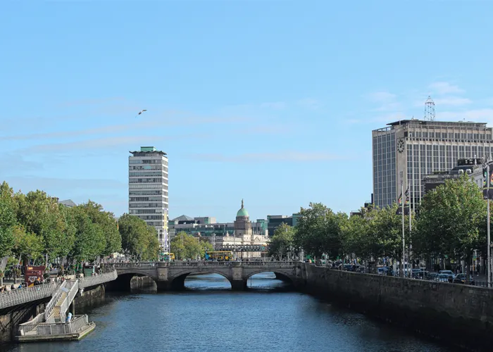Sunny view of Dublin city with the River Liffey, O’Connell Bridge and landmark buildings including Liberty Hall, lining the quays.